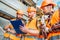 bottom view of group of builders in hard hats and reflective vests looking