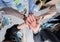 Bottom view of a group of businessmen and women wear a mask and take hand coordination in the office. Job successes and teamwork