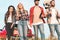 bottom view of group of young fiends with beer bottles and guitar walking