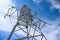 Bottom view of a high voltage power tower with glass insulators