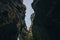 bottom view between majestic rocks at blue sky with flying birds, raudfeldsgja