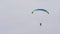 Bottom view of man with parachute in sky. Action. Person flies in sky on paraglider in cloudy weather. Extreme sports
