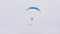 Bottom view of man with parachute in sky. Action. Person flies in sky on paraglider in cloudy weather. Extreme sports
