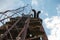 Bottom view of old rusty steps on a metal tower, selective focus