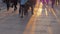 Bottom view of people legs against sunset rays on the paving stone