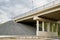 Bottom view of the prestressed concrete beams and piers of bridge crossing many-lane expressway of road