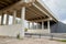 Bottom view of the prestressed concrete beams and piers of bridge crossing many-lane expressway of road