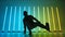 Bottom view of a professional break dancer performing against a backdrop of bright neon lights. Silhouette of stylish