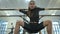 Bottom view of slim gorgeous brunette dancer moving in slow motion standing in spider pose at dance barre in dance