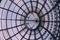Bottom view to geometric glass ornate round roof of Galleria Vittorio Emanuele II,Milan,Italy