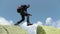 Bottom view of a tourist-climber walking along the rocky mountains.