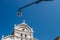 Bottom view of Traditional street lamp and an famous old Venetian church building in the middle of the day with a blue