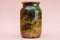 Botulism, food poisoning from canned foods concept. Glass jar wi