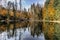 Boubin lake. Reflection of fall trees of Boubin Primeval Forest, Sumava Mountains, Czech Republic.Water reservoir located at the