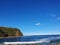 Boudi national park beach with blue clear sky surrounding sea and lots of greenness