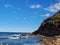 Boudi national park beach with blue clear sky surrounding sea and lots of greenness