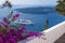 Bougainvillea adorn walkway as passenger cruise ship anchors off the coast of Greece