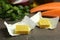 Bouillon cubes and other ingredients for soup on wooden table, closeup