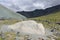 Boulder with the image of the sign Banner of Peace in the gorge of Yarlu on the background of colored mountains, Altai, Russia