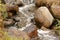 boulders in creek with water cascading over