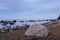 Boulders on a sea shore. Wild rocky seashore on a cloudy day. Fabulous seascape