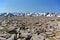 Boulders on the summit of Ben Macdui with snow-covered ridge in the background