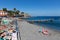 Boulevard and beach with unknown sunbathing and swimming people at Madeira, Portugal