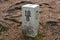 Boundary marker border stone in forest border, mountains