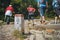 Boundary stone marking the border of Poland  where tourists are just walking.