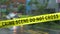 Boundary tape and defocused squad car at crime scene