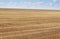 Boundless fields after harvest in Summer time.