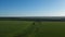 Boundless green rice field against distant village by pictorial hills