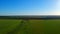 Boundless green rice field against distant village by pictorial hills