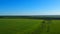 Boundless green rice field against distant village by pictorial hills