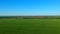 Boundless green rice field against distant village by pictorial hills