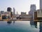 The boundless swimming pool in the hotel on the roof with a view of the houses in the city center.