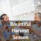 Bountiful harvest season text over happy caucasian family toasting at thanksgiving dinner