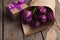 Bouqet of purple tulips and gift box on wooden background