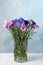 Bouquet of beautiful cornflowers in glass vase on white table