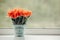Bouquet of beautiful orange peony tulips in a bucket on a windowsill