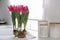 Bouquet of beautiful tulips with bulbs on countertop in kitchen