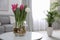 Bouquet of beautiful tulips with bulbs on table indoors. Space for text