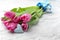 Bouquet of beautiful tulips and small cotton heart on light wooden background