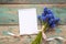 Bouquet of blue muscaries flowers with open blank notepad on old