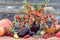 Bouquet of bright physalis with vegetables and fruits lying on the table on a wooden background, side view, autumn still life