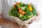 Bouquet of broccoli, celery, carrots, paprika and lettuce in the hands of a woman