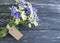 Bouquet camomile, cornflower on black wooden background