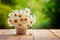 Bouquet of camomile flowers on wood table in nature green backgr