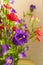 Bouquet of Canterbury bells purple flower blooming Campanula medium and red small carnations. Unpretentious and delicate violet