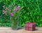 Bouquet of carnations in a glass vase and a brown box with a gift